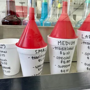 Sizes and prices. Kids size (far left) is flat top while the other three are coned top.