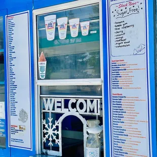 a blue food truck with menus
