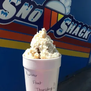 a hand holding a cup of ice cream