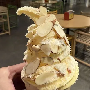 Pineapple soft serve with coconut flakes and sliced almonds