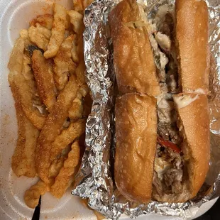 Philly cheese steak with peppers and onions seasoned fries. Delicious!!