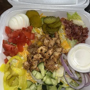 a salad in a styrofoam container