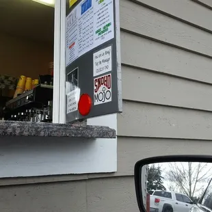 a red button on the side of a house