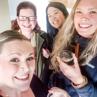 a group of women holding wine glasses