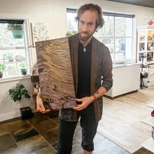 a man holding a large piece of wood