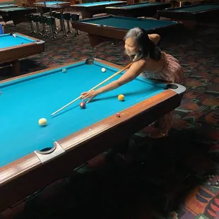 a woman playing pool