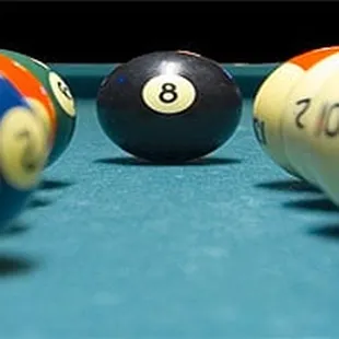 a pool table with a pool ball in the middle