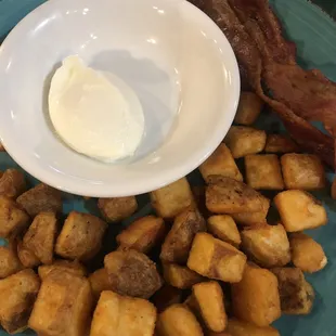 One egg breakfast with home fries and bacon