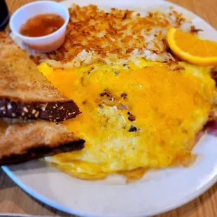 Snooty pig omlette with crispy hashbrowns and wheat toast.