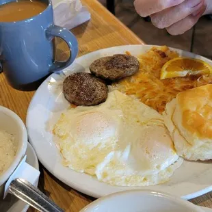 2 eggs over easy, biscuit, hashbrowns, sausage, and added grits.