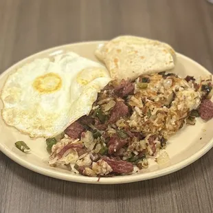 Corned Beef Hash*: shredded hash mixed w/corned beef, caramelized poblanos &amp; onions w/over easy eggs &amp; flour tortillas | $15.75