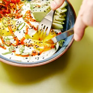  a person eating a bowl of food