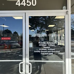 Front door with hours, address and name.