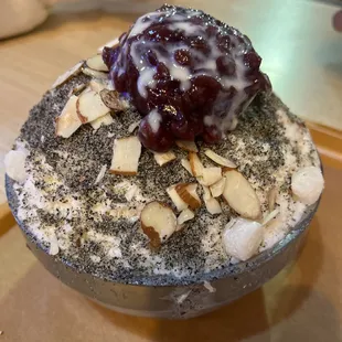 an ice cream sundae topped with almonds and cherries