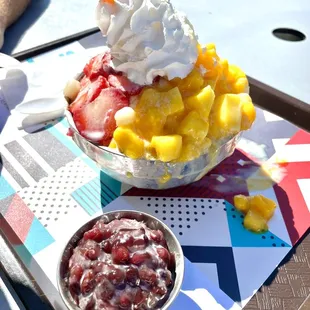 a bowl of fruit and whipped cream