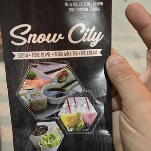 a hand holding a menu