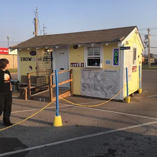 a woman standing in front of a small store