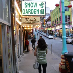 a woman walking down the sidewalk