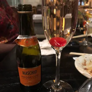 a bottle of maschio and a glass of wine