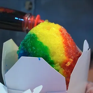 a rainbow cake in a paper cup