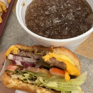 Deluxe burger and huge drink with crushed ice