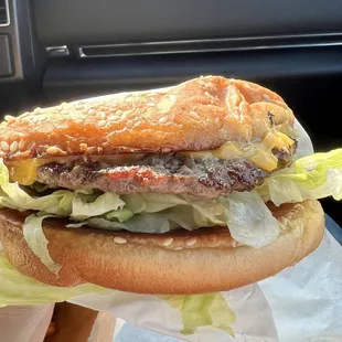 a hamburger with lettuce and cheese