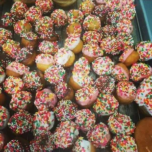 a tray of sprinkled donuts