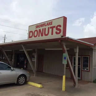 a car parked in front of a donut shop