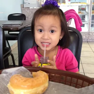 a little girl drinking a drink