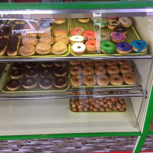 a variety of donuts in a display case