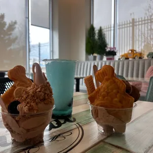 two ice cream sundaes on a table