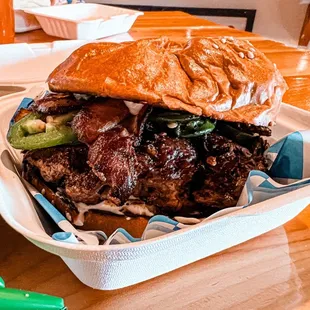 a beef sandwich in a styrofoam container