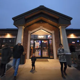 people walking in front of the restaurant