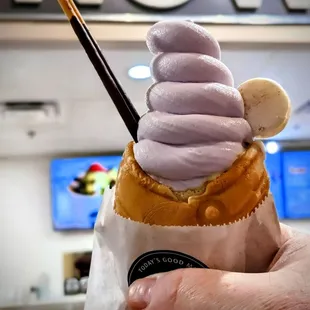 a hand holding an ice cream cone