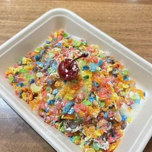 a bowl of cereal with a cherry on top