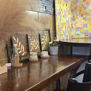 a wooden table with chairs and a quilt on it