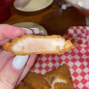 a person holding a piece of food