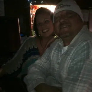 a man and a woman sitting at a bar