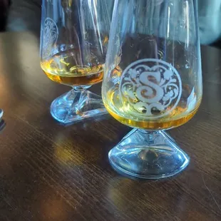 two glasses of alcohol on a table