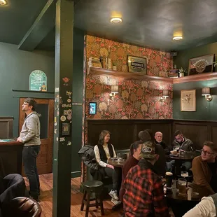 a group of people sitting at tables in a restaurant