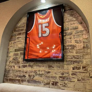a basketball jersey hanging on the wall