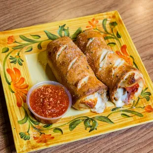 a plate of pizza and dipping sauce