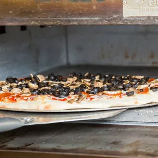 a pizza being cooked in an oven