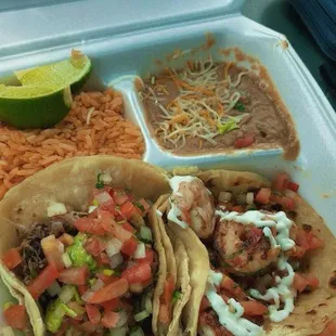 Combo 2 with a Shrimp Taco and Carnitas Taco, rice and beans.