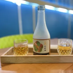 a bottle of sake and two glasses