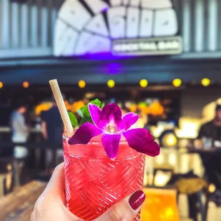 a hand holding a drink