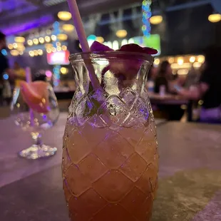 a pineapple drink in a glass