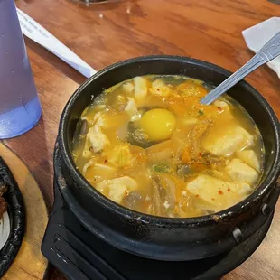 a bowl of soup and a plate of meat