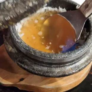 I am guessing it is Sungnyung, a drink made from simmering water with the crust of rice formed at the bottom of a pot of rice