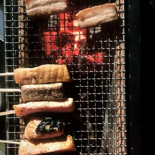 a bunch of meat on a grill
